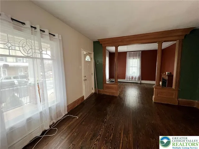 a view of a room with wooden floor