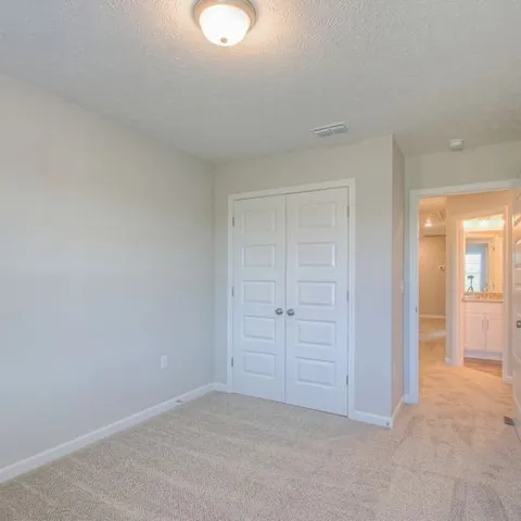 an empty room with closet area