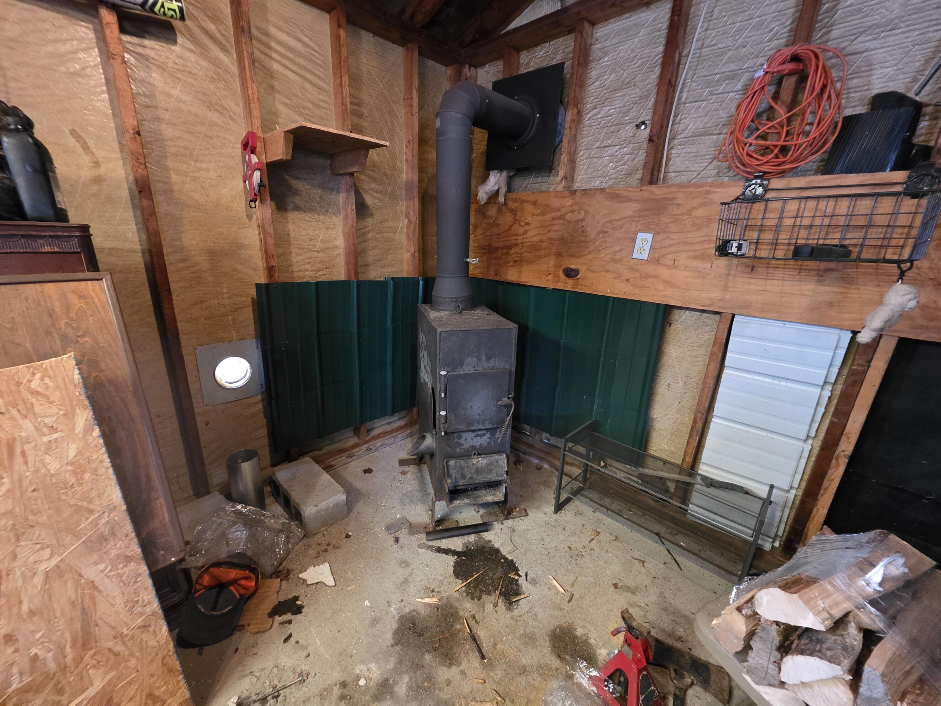 46 Cedar Street Millinocket, ME 04462 - Photo 39 of 40 woodstove in garage (1)