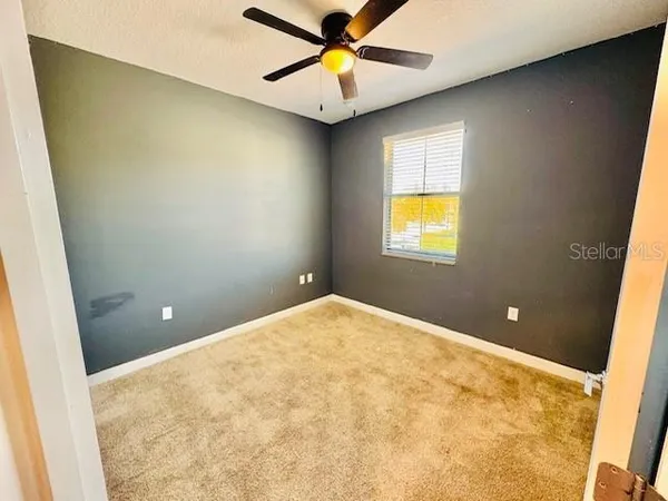 a bathroom with a chandelier fan and window