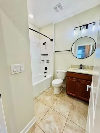 a bathroom with a bathtub sink mirror and toilet