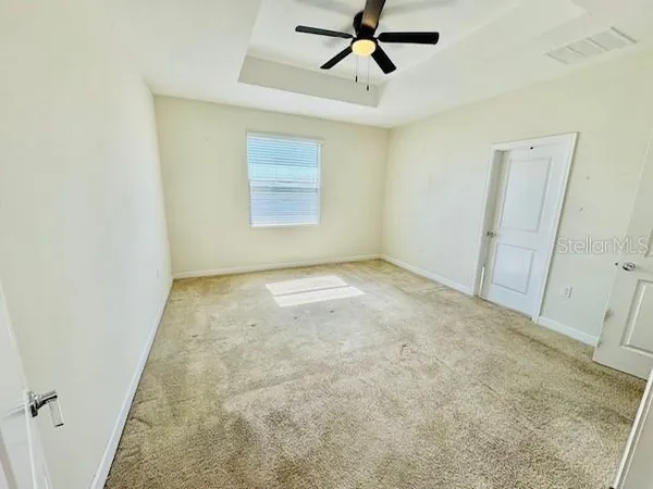 a view of room with a ceiling fan and window
