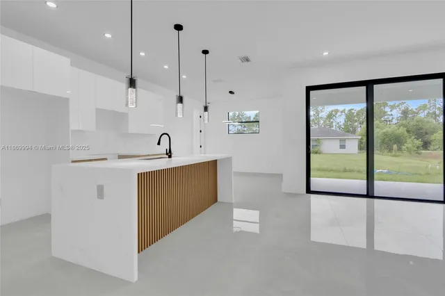 an empty room with glass door and shower