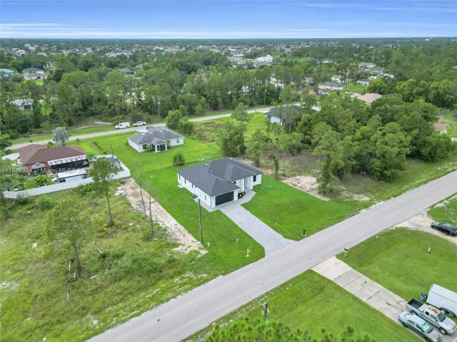 a view of a city with lush green forest