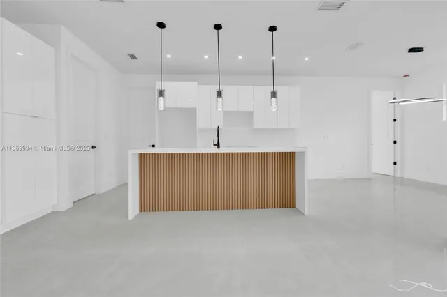 a view of a kitchen with a sink and a window