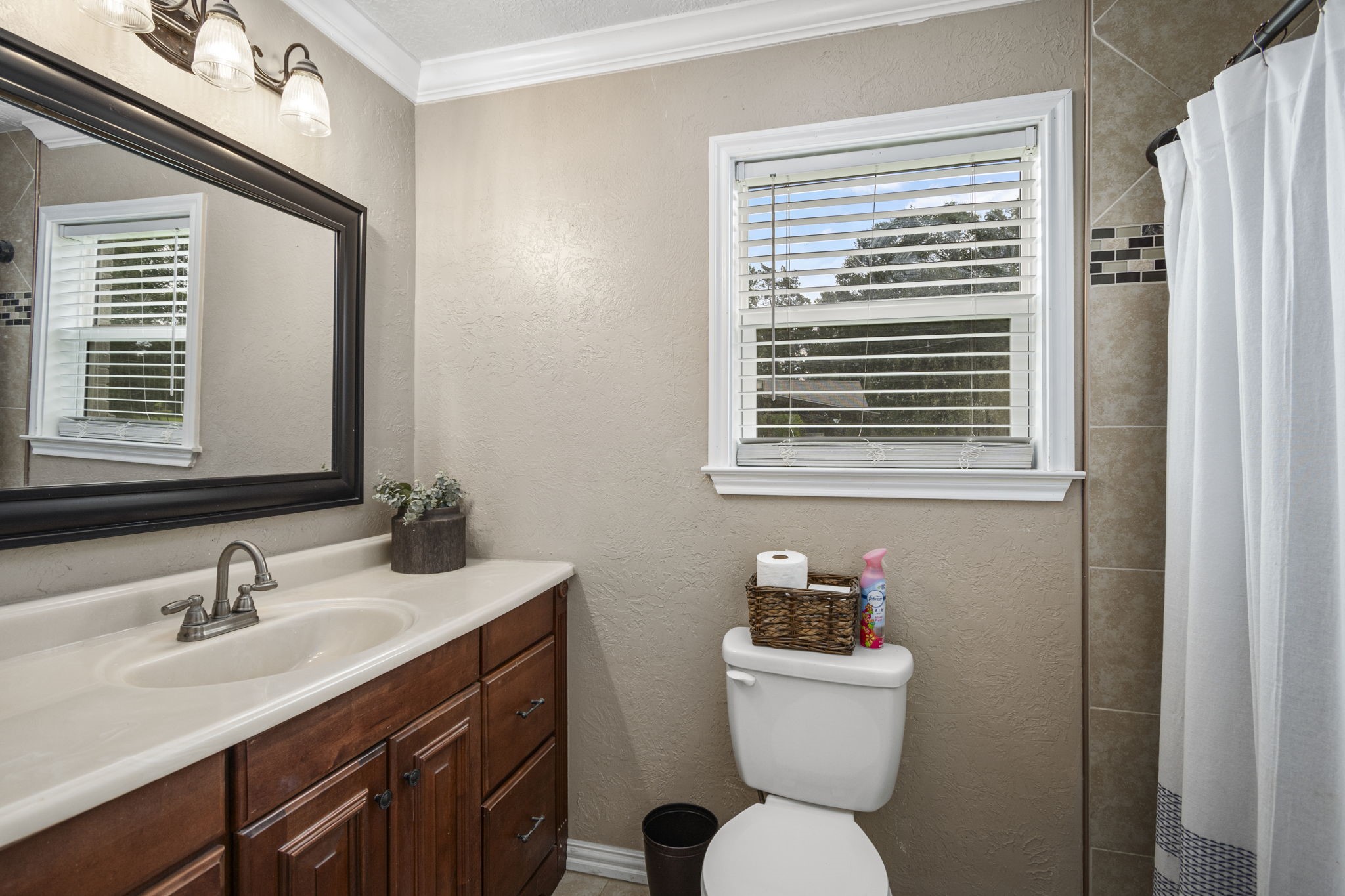 25311 Hardin Store Road Pinehurst, TX 77362 - Photo 18 of 39 a bathroom with a sink a toilet and a mirror