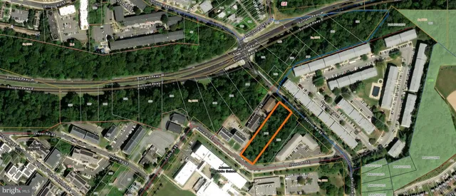 an aerial view of a residential apartment building with a yard