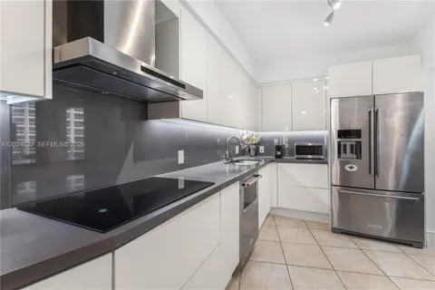 a kitchen with a refrigerator sink and cabinets
