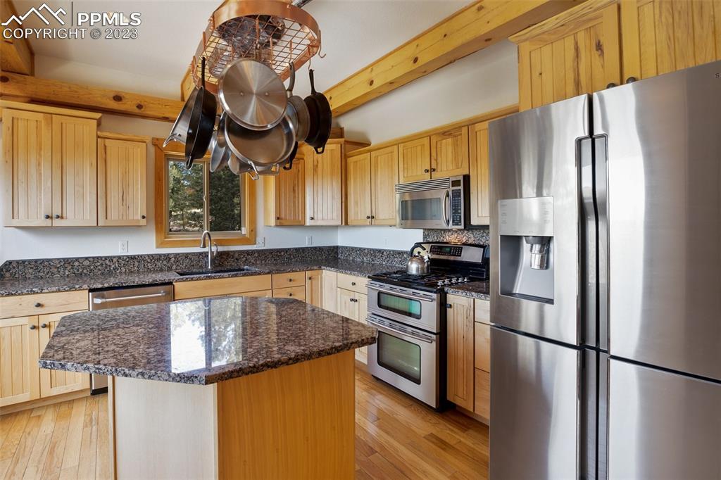 1201 County Road 512 Divide, CO 80814 - Photo 18 of 43 a kitchen with granite countertop stainless steel appliances a refrigerator a sink and cabinets