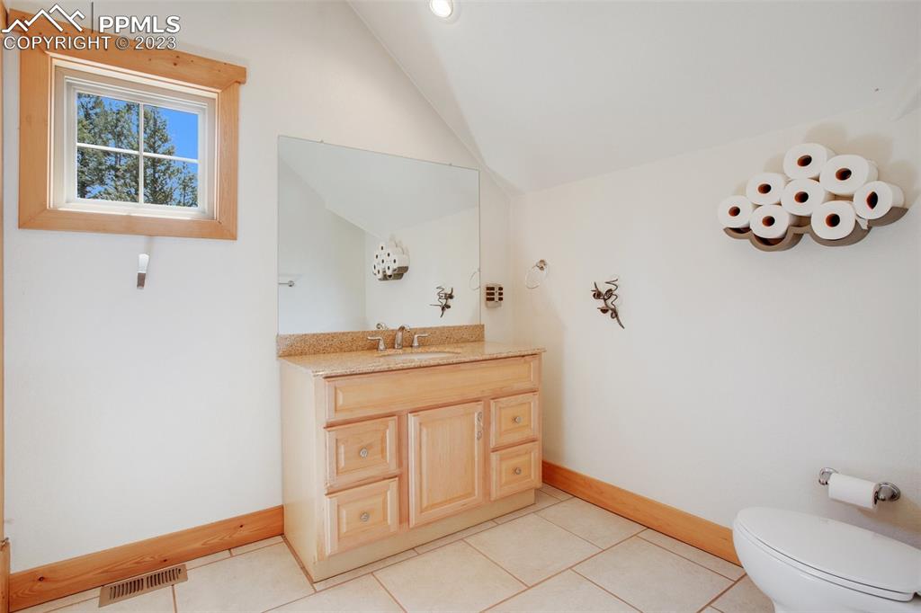 1201 County Road 512 Divide, CO 80814 - Photo 28 of 43 a bathroom with a sink mirror and vanity