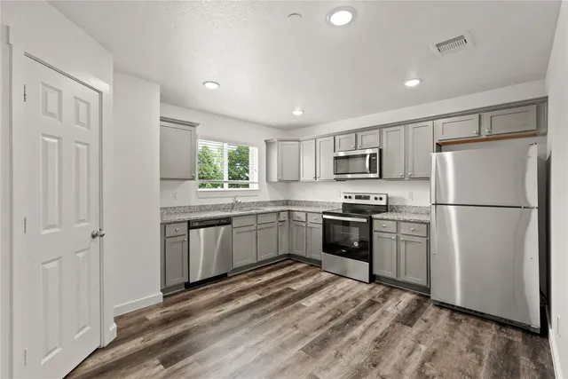 a kitchen with a refrigerator stove and microwave