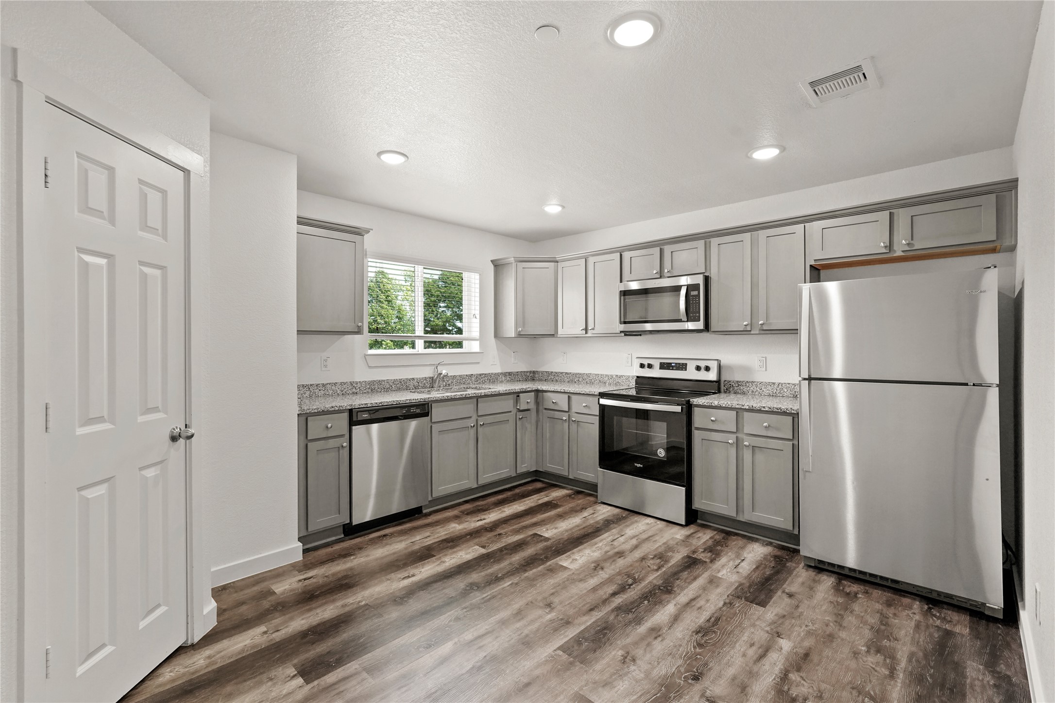 a kitchen with a refrigerator stove and microwave