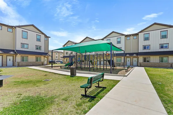 a view of a house with swimming pool and sitting area