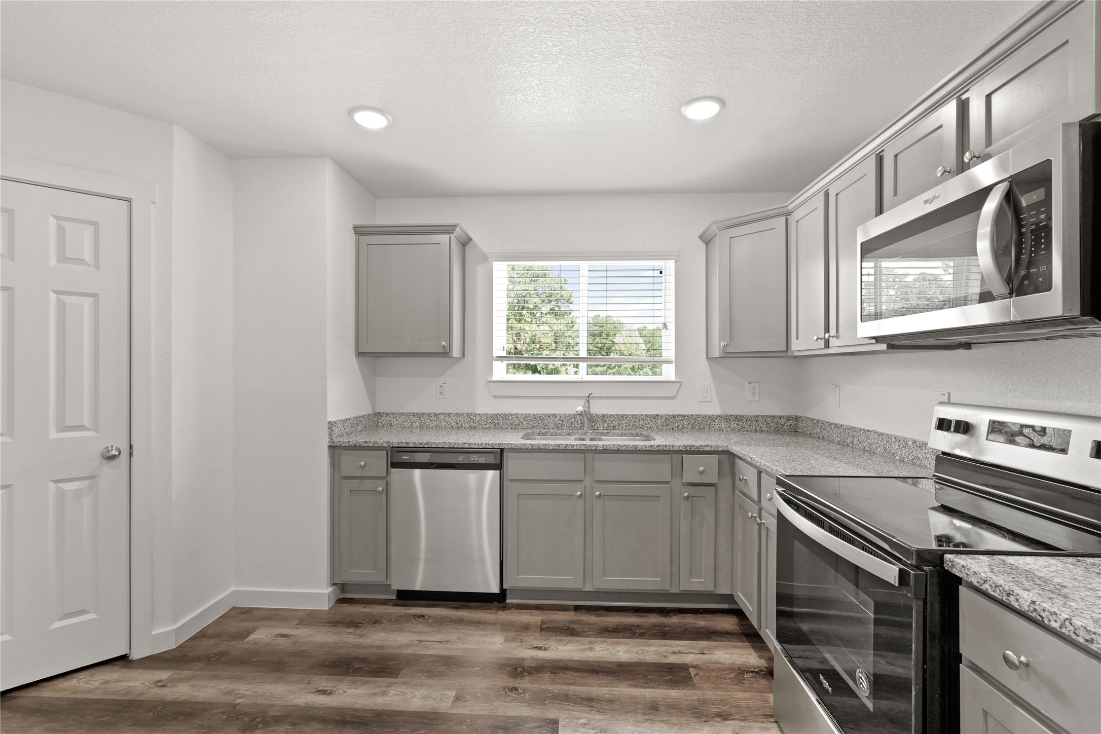 12603 Telge Road, Unit 7L Cypress, TX 77429 - Photo 2 of 20 a kitchen with stainless steel appliances granite countertop a sink stove and microwave