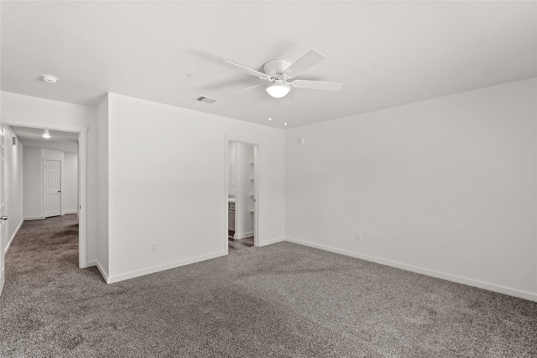 12603 Telge Road, Unit 7L Cypress, TX 77429 - Photo 9 of 20 an empty room with a ceiling fan and a bathroom
