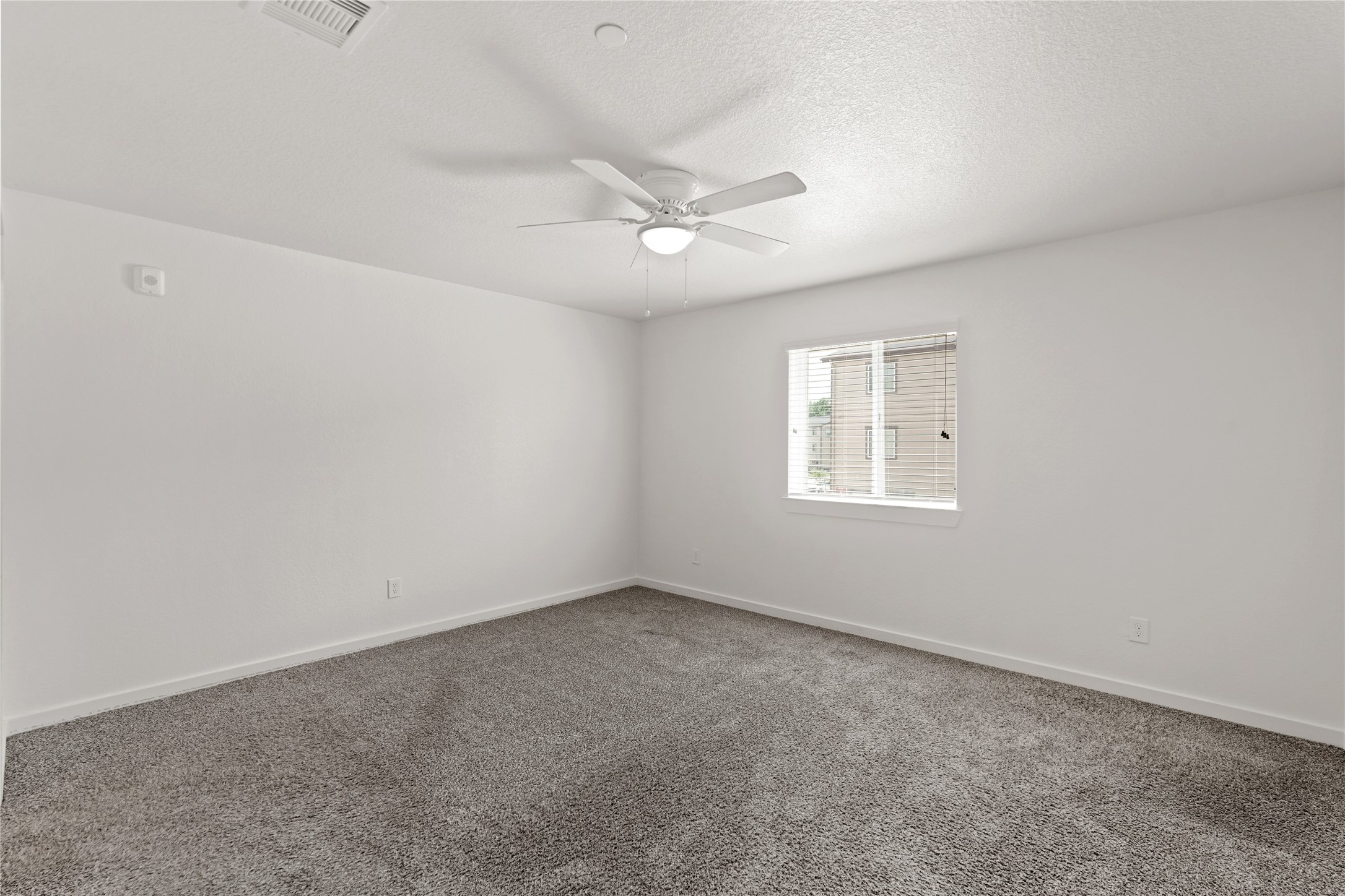 12603 Telge Road, Unit 7L Cypress, TX 77429 - Photo 10 of 20 an empty room with a window and ceiling fan