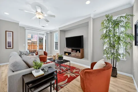 a living room with furniture a large window and a flat screen tv
