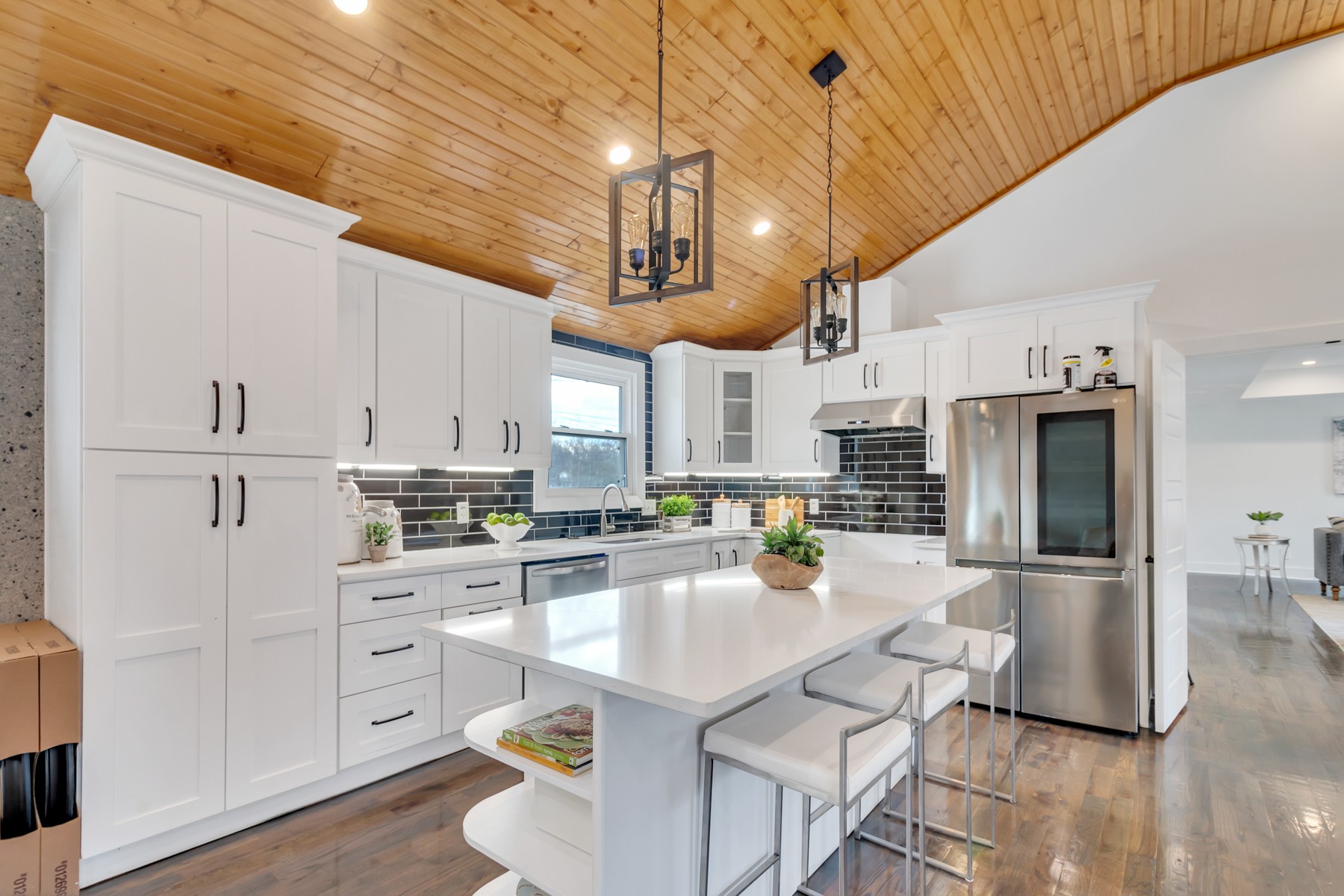 4778 Drakes Branch Road Nashville, TN 37218 - Photo 7 of 17 a kitchen with stainless steel appliances kitchen island granite countertop a refrigerator a stove a sink dishwasher and white cabinets with wooden floor