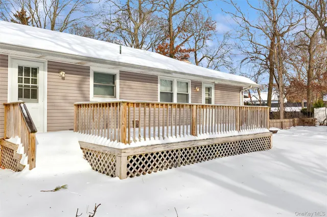 a view of a house with a wooden fence