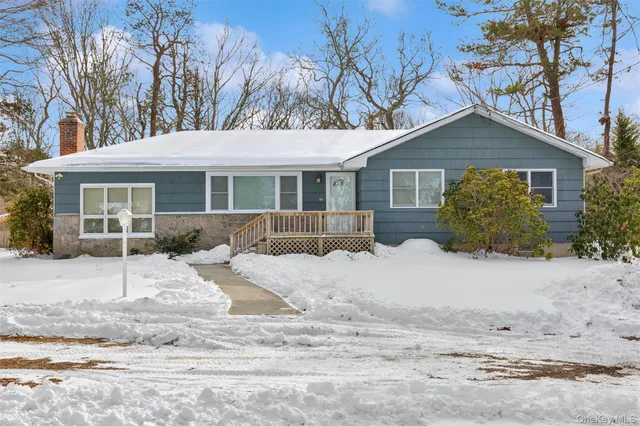 a view of a house with a yard covered in snow