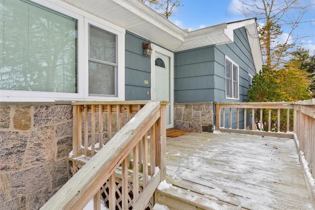 a view of a balcony with wooden floor and fence