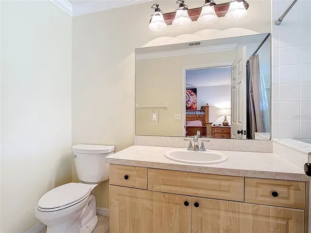 a bathroom with a sink toilet and mirror