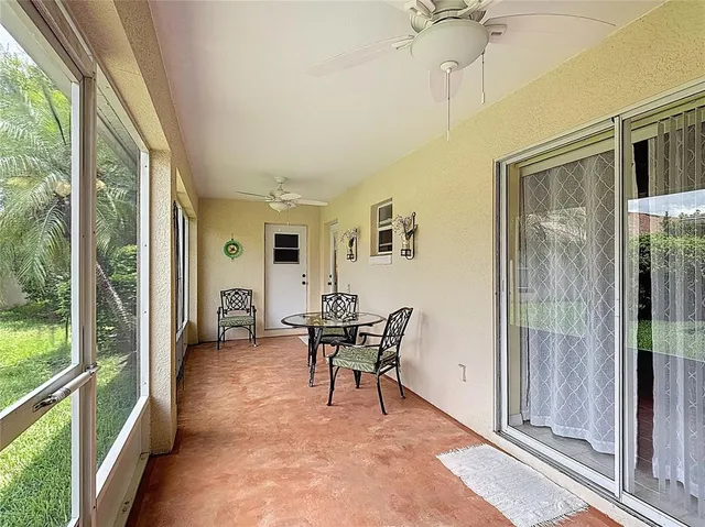 a dining room with furniture and a floor to ceiling window