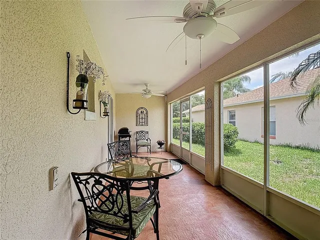 a dining room with furniture a chandelier and wooden floor