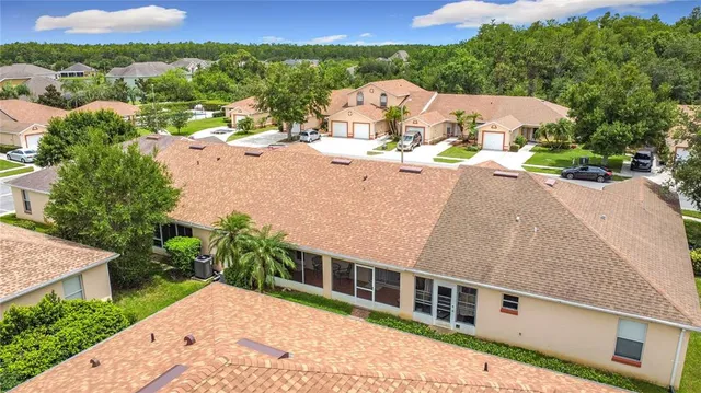 an aerial view of a house with a yard and lake view