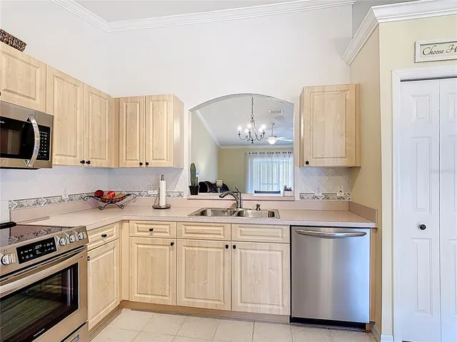 a kitchen with white cabinets and appliances