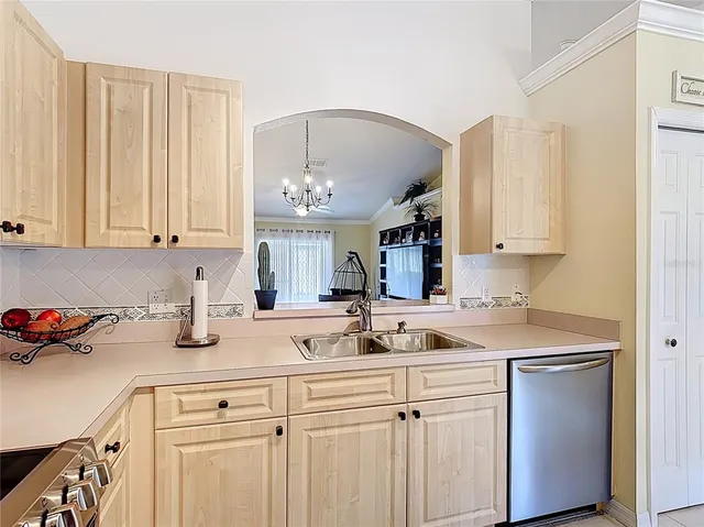 a kitchen with a sink cabinets and window