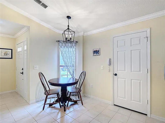 a view of a dining room with furniture and window