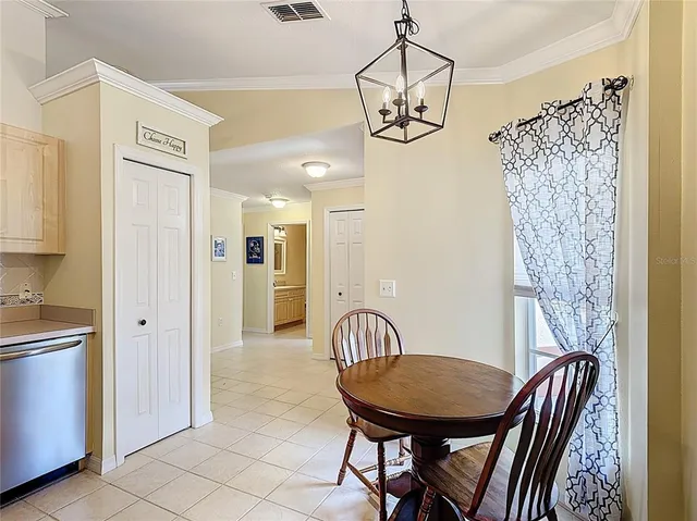 a view of a dining room with furniture and a chandelier