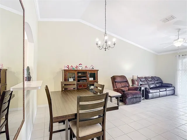 a dining room with furniture and chandelier