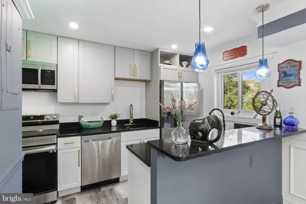 a kitchen with stove and cabinets