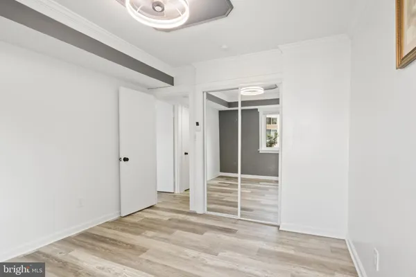a view of wooden floor and closet in a room