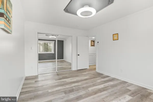 a view of a livingroom with wooden floor and windows