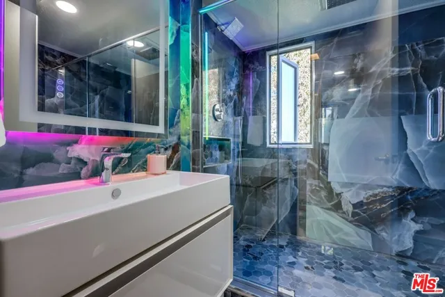 a bathroom with a bathtub a sink and a mirror