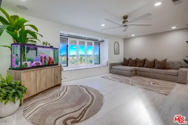a living room with furniture and a potted plant