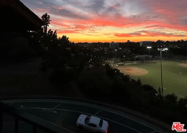 a kitchen with stainless steel appliances kitchen island granite countertop a stove a sink and a microwave