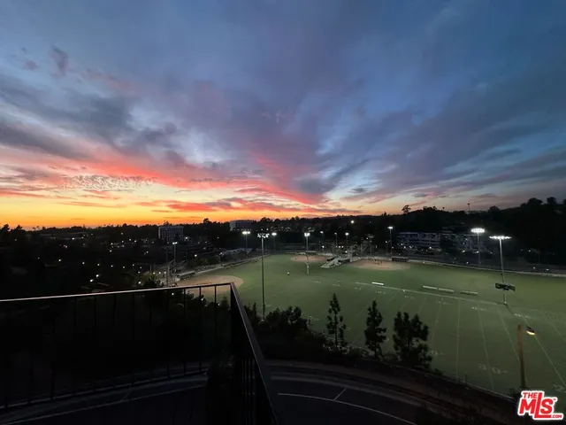 a living room with furniture a fireplace and kitchen view