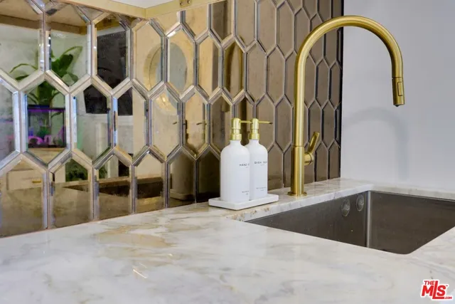 a kitchen with kitchen island stainless steel appliances a table and chairs in it