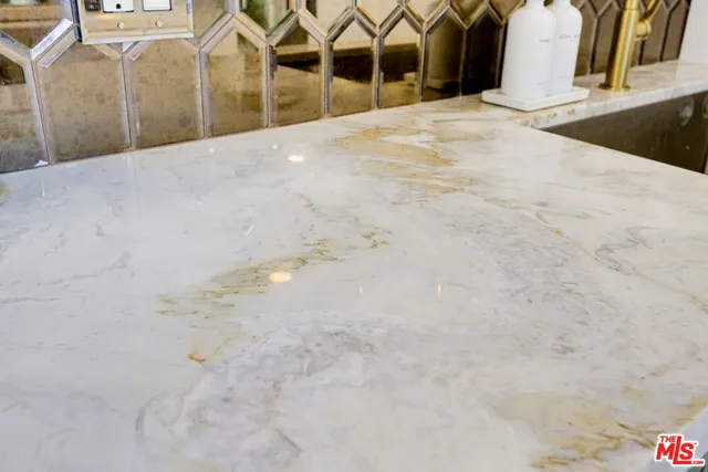 a living room with furniture kitchen and a chandelier