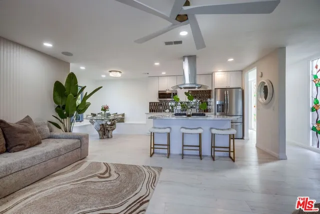 a bedroom with a large bed and a mirror