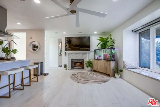 a bathroom with a granite countertop sink mirror vanity and toilet