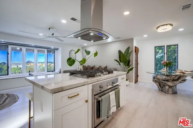 a kitchen with stainless steel appliances granite countertop a stove and a sink