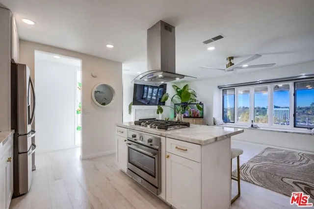 a kitchen with stainless steel appliances granite countertop a stove and a refrigerator