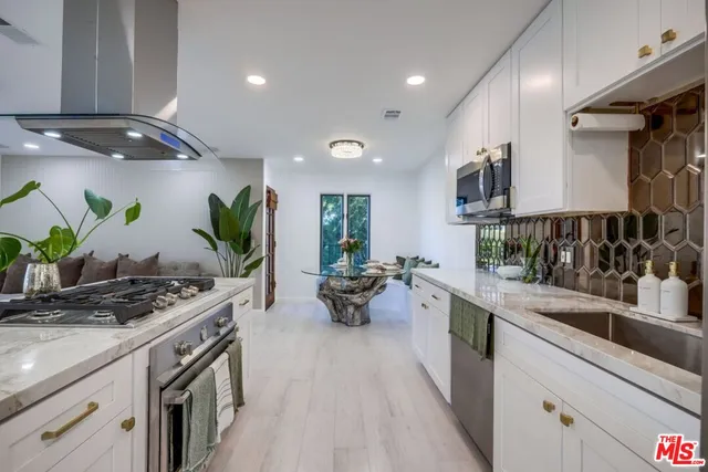 a kitchen with a sink and stove in it