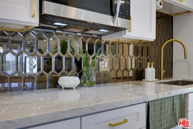 a living room with furniture a potted plant and a sink