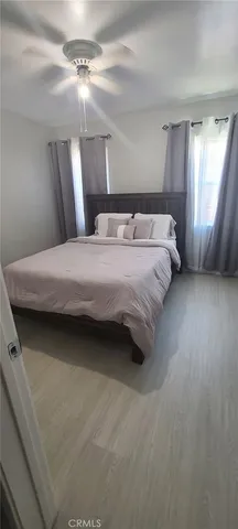 a bedroom with bed and window